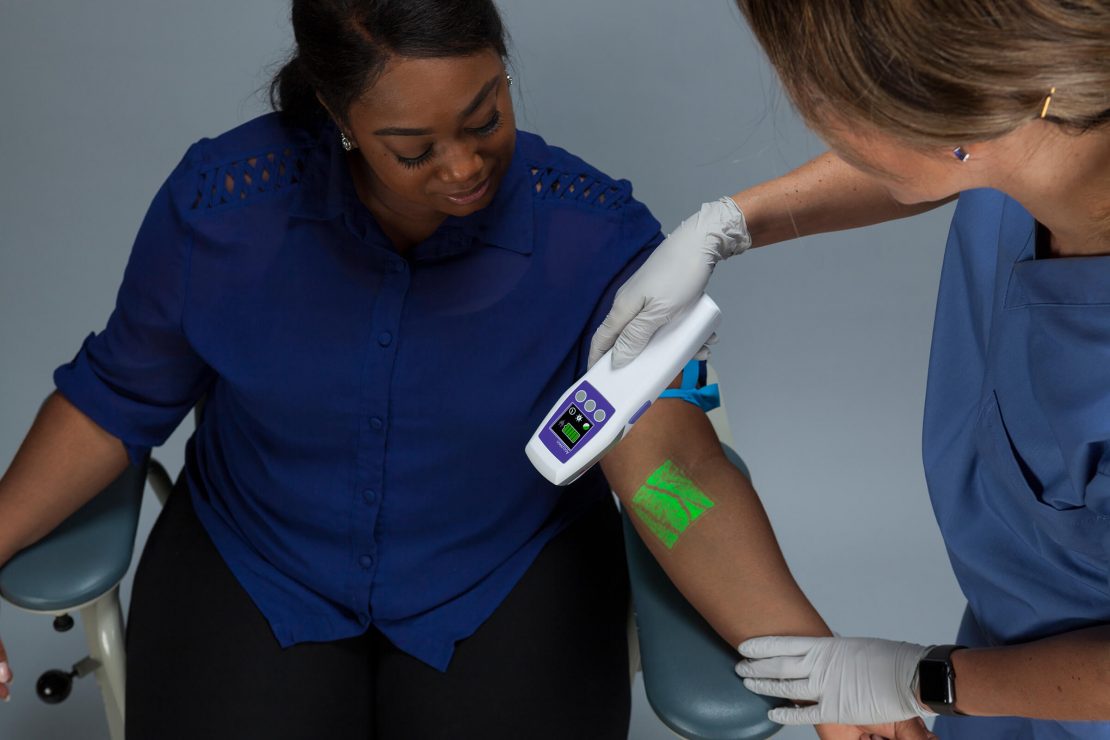 AccuVein Vein Finder scanning a patient's arm